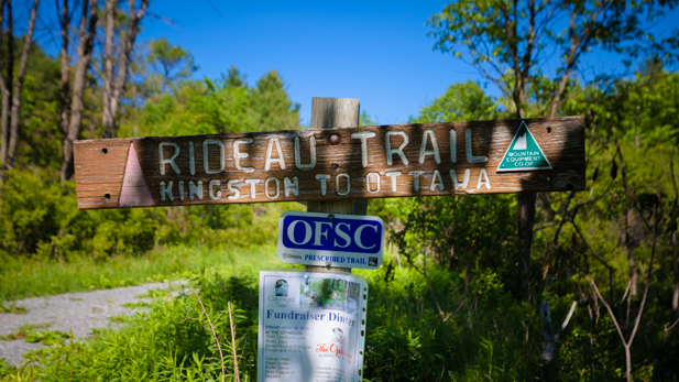 The Rideau Trail weaves across sections of the Cataraqui Trail. You'll know you're on the Rideau Trail when you see orange triangular trail markers.
